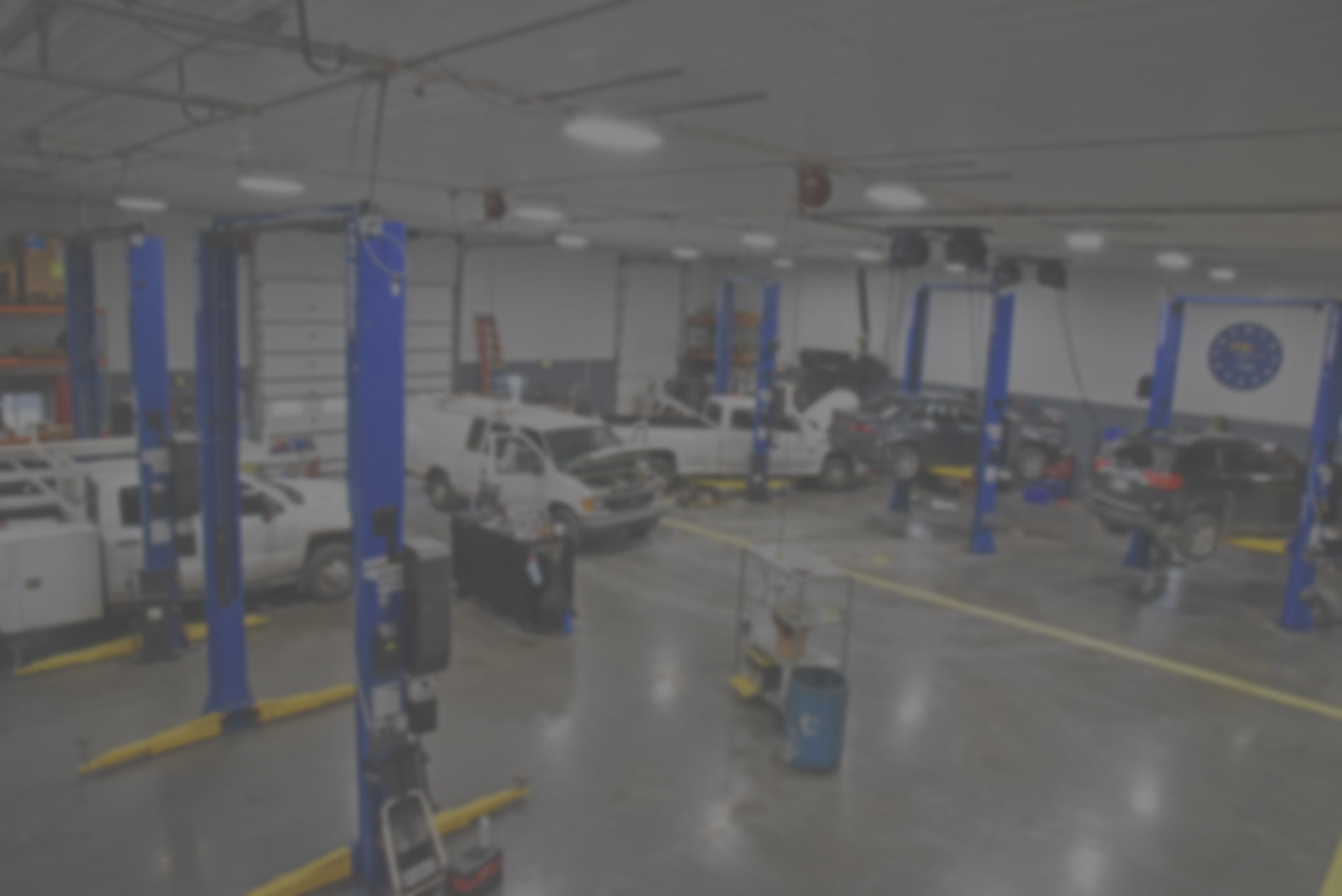 Inside garage showing cars on lift